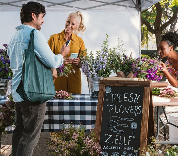 People at local market flower stand